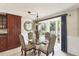 Cozy dining area with glass table and four chairs, located by kitchen at 4696 Pompano St, Placida, FL 33946