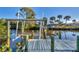 Wooden dock with boat lift and canal views at 4696 Pompano St, Placida, FL 33946