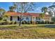 Single story home with terracotta tile roof and manicured lawn at 4696 Pompano St, Placida, FL 33946