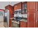 Kitchen features wood cabinets, granite countertops, and stainless steel appliances at 4696 Pompano St, Placida, FL 33946