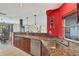 Kitchen boasts granite countertops, stainless steel appliances, and red accent wall at 4696 Pompano St, Placida, FL 33946