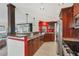 Open kitchen with granite countertops, stainless steel appliances, and breakfast bar at 4696 Pompano St, Placida, FL 33946