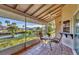 Screened porch with table and chairs, overlooking canal at 4696 Pompano St, Placida, FL 33946