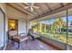 Relaxing screened porch with seating and water view at 4696 Pompano St, Placida, FL 33946