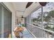 Relaxing screened balcony offers seating and ceiling fan at 5031 N Beach Rd # 116, Englewood, FL 34223