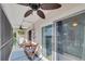 Private screened balcony with outdoor seating and ceiling fan at 5031 N Beach Rd # 116, Englewood, FL 34223