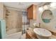 Bathroom features a modern sink, granite counters and tub with shower at 5031 N Beach Rd # 116, Englewood, FL 34223