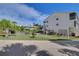 Exterior view of multi-story house, palm trees and lawn at 5031 N Beach Rd # 116, Englewood, FL 34223