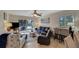 Cozy living room with a comfortable sofa, chairs, and access to the balcony at 5031 N Beach Rd # 116, Englewood, FL 34223