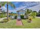 Community pool with brick pathway and lush landscaping at 5031 N Beach Rd # 116, Englewood, FL 34223