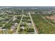 Wide shot of neighborhood with various houses and lush vegetation at 5400 Jennings Blvd, Port Charlotte, FL 33981