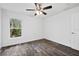 Simple bedroom with ceiling fan and large window at 5400 Jennings Blvd, Port Charlotte, FL 33981