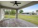 Relaxing screened porch with tile flooring and ceiling fan, overlooking backyard at 5400 Jennings Blvd, Port Charlotte, FL 33981