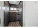 Large walk-in shower with dark tile and patterned floor at 5400 Jennings Blvd, Port Charlotte, FL 33981