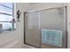 Shower with glass enclosure and light blue mat at 609 Deerwood Ave, Englewood, FL 34223