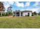 Large backyard showcasing the home's exterior and patio at 6256 Pennell St, Englewood, FL 34224