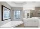 Bathroom with corner tub, vanity, and shower at 6256 Pennell St, Englewood, FL 34224