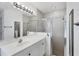 Clean bathroom with vanity, shower, and mirror at 6256 Pennell St, Englewood, FL 34224