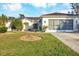 Single-story home with a two-car garage and well-manicured lawn at 6256 Pennell St, Englewood, FL 34224