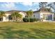 Single story home with attractive landscaping and a two-car garage at 6256 Pennell St, Englewood, FL 34224