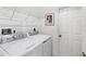 Laundry room with washer, dryer, and shelving at 6256 Pennell St, Englewood, FL 34224