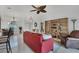 Living room with red couch, built-in shelving, and patio access at 6256 Pennell St, Englewood, FL 34224