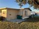 Rear view of manufactured home showing storage shed and utilities at 6276 Greenfinch Rd, Englewood, FL 34224