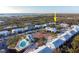 Aerial view of waterfront community with tennis courts, pool, and lush landscaping at 6800 Placida Rd # 165, Englewood, FL 34224