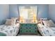 Guest bedroom with twin beds, dresser, and soft blue walls at 6800 Placida Rd # 165, Englewood, FL 34224