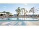 Sparkling community pool with surrounding lounge chairs at 6800 Placida Rd # 165, Englewood, FL 34224