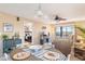 Bright dining area with table set for four, view into living room and bedroom at 6800 Placida Rd # 165, Englewood, FL 34224