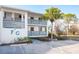 Two-story building with grey railings and parking at 6800 Placida Rd # 165, Englewood, FL 34224