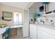 Laundry room with washer, dryer, and storage shelves at 6800 Placida Rd # 165, Englewood, FL 34224