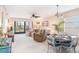 Spacious living room features comfortable seating, a dining area, and access to a screened porch at 6800 Placida Rd # 165, Englewood, FL 34224