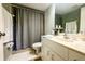 Clean bathroom with shower/tub combo, vanity, and white cabinetry at 8050 Memory Ln # 104, Rotonda West, FL 33947