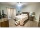 Bright bedroom with a queen-size bed, wood furniture, and sliding door access at 8050 Memory Ln # 104, Rotonda West, FL 33947