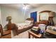 Cozy bedroom with a full-size bed, dresser, and desk area at 8050 Memory Ln # 104, Rotonda West, FL 33947