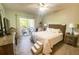 Bedroom with a queen bed and access to a balcony overlooking the backyard at 8050 Memory Ln # 104, Rotonda West, FL 33947