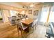 Bright dining room with a wooden table and chairs adjacent to kitchen at 8050 Memory Ln # 104, Rotonda West, FL 33947