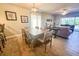 Spacious dining area with a wooden table and chairs, hardwood floors, and access to the living room at 8050 Memory Ln # 104, Rotonda West, FL 33947