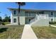 Two-story condo building with stairs and walkway at 8050 Memory Ln # 104, Rotonda West, FL 33947