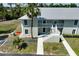 Two-story condo building with stairs, balconies, and lush landscaping at 8050 Memory Ln # 104, Rotonda West, FL 33947