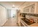 Modern kitchen featuring white cabinets, tile floors, and stainless steel appliances at 8050 Memory Ln # 104, Rotonda West, FL 33947