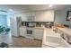 Bright kitchen with white cabinets, tile backsplash, and stainless steel appliances at 8050 Memory Ln # 104, Rotonda West, FL 33947