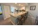 Kitchen with breakfast bar and seating, white cabinets, and tile flooring at 8050 Memory Ln # 104, Rotonda West, FL 33947