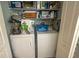 Convenient laundry room with washer, dryer, and ample storage shelving at 8050 Memory Ln # 104, Rotonda West, FL 33947