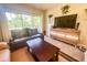 Living room with two sofas, a coffee table, and a large flat screen TV at 8050 Memory Ln # 104, Rotonda West, FL 33947