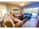 Relaxing living room with comfortable sofas, a coffee table, and large window at 8050 Memory Ln # 104, Rotonda West, FL 33947