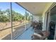 Relaxing screened porch with patio furniture, overlooking a lush backyard at 8050 Memory Ln # 104, Rotonda West, FL 33947