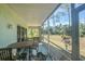 Relaxing screened porch with outdoor furniture and view of backyard at 8050 Memory Ln # 104, Rotonda West, FL 33947